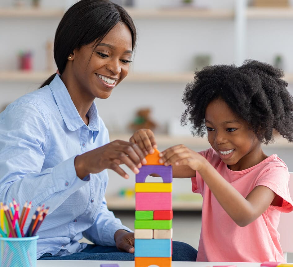 stock-photo-adorable-black-kid-curly-little-girl-and-child-development-specialist-attractive-young-woman-2119998428 2