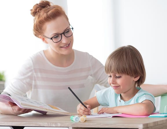 stock-photo-education-concept-smiling-little-boy-studying-with-friendly-young-home-tutor-during-private-lesson-738097555 2